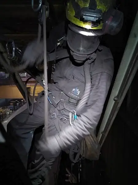 Cordiste de Marseille équipé d'un masque ventilé lors de la pose de filets anti-chute